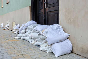 Sandbags stacked in front of door to protect building from flood water. Emergency defense measure...