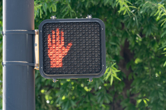 Illuminated led orange hand stop do not walk crosswalk sign with copy space