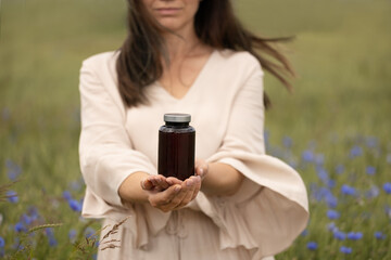 Mockup Bottle Held by Woman in Nature