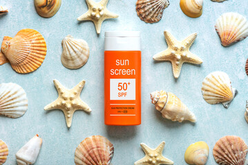 Top view of bottle of sunscreen with 50+ written on it and starfishs. Concept of sun protection