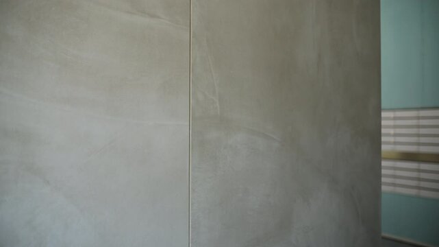Installed porcelain stoneware tiles on interior wall