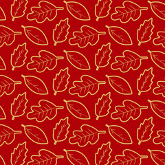 Seamless leaf pattern with hand drawn golden leaves on a rich red background.