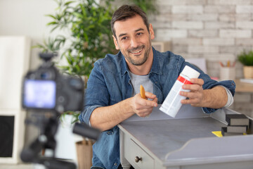 happy man recording video for his blog