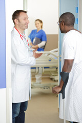Fototapeta premium doctor talking to patient in hallway