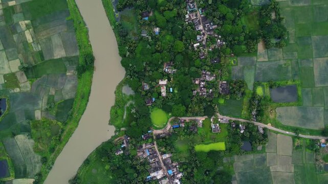 Indian village top view in monsoon. indian road and indian river goes through a village. 