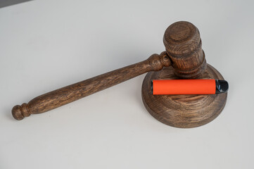Judge's gavel and e-cigarette. Smoking ban. Tobacco heating systems. 