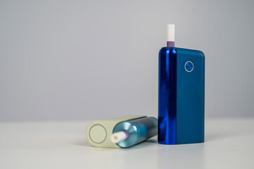 Two electronic cigarettes on a white background. Tobacco heating systems.