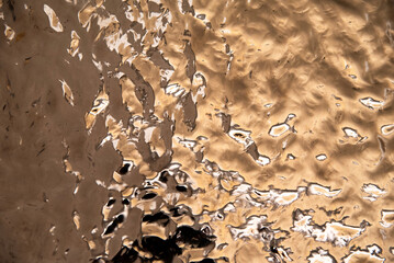 Shiny liquid gold metal with abstract texture