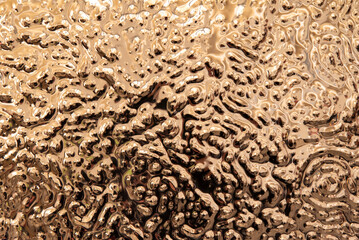 Glossy gold liquid metal abstract texture