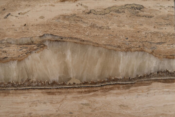 Natural layered travertine stone texture in warm beige tones