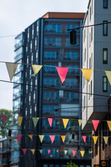 Close view of urban flags between tall buildings.