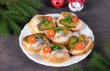 Homemade sandwiches with salted herring, melted cheese, carrot and pickled cucumber
