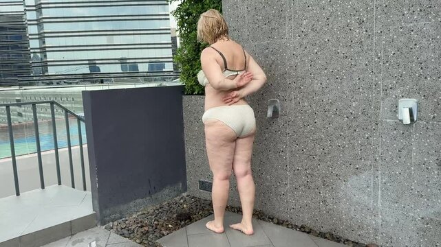 plump adult woman in the shower outside