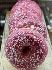 Enjoy delightful Pink Frosted Donuts with colorful sprinkles, perfect for any occasion. A wonderfully tempting display of pinkfrosted donuts that are beautifully topped with colorful sprinkles