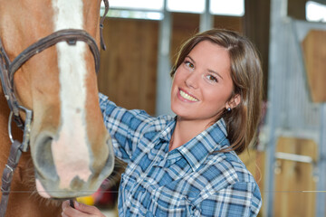 girl with horse in a stable