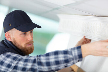 foreman checking accuracy with a bubble spirit level