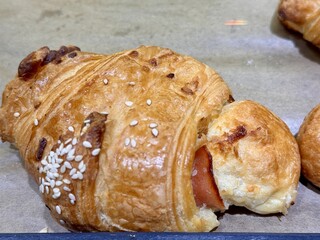 A delightful stack of warm, freshly baked, golden croissants is beautifully arranged. An enticing tower of perfectly baked golden croissants, showcasing their flaky and delightful texture beautifully