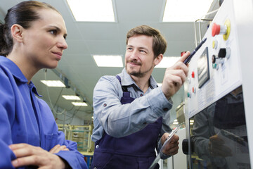 adult male worker with female apprentice working