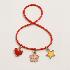 Colorful hair tie with enamel charms in heart, flower, and star shape  