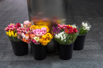 Buckets of Colorful Flowers on a City Street