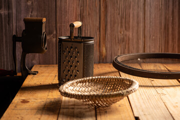 Sieves and accessories on a rustic wooden table, selective focus