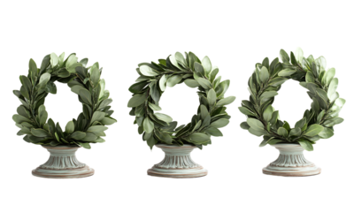 Elegant laurel wreaths displayed on decorative bases isolated on transparent background.