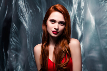 Stunning attractive Woman with Red Hair Majestically Posing Indoors Against a Stylish Translucent...