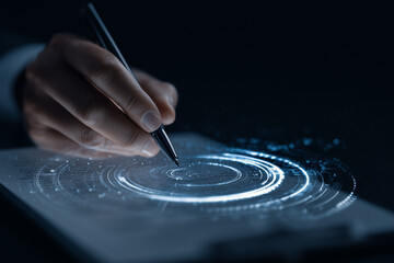 Person drawing circle with pen on digital interface