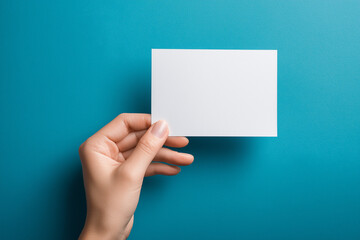 Hand holding card on blue background mockup