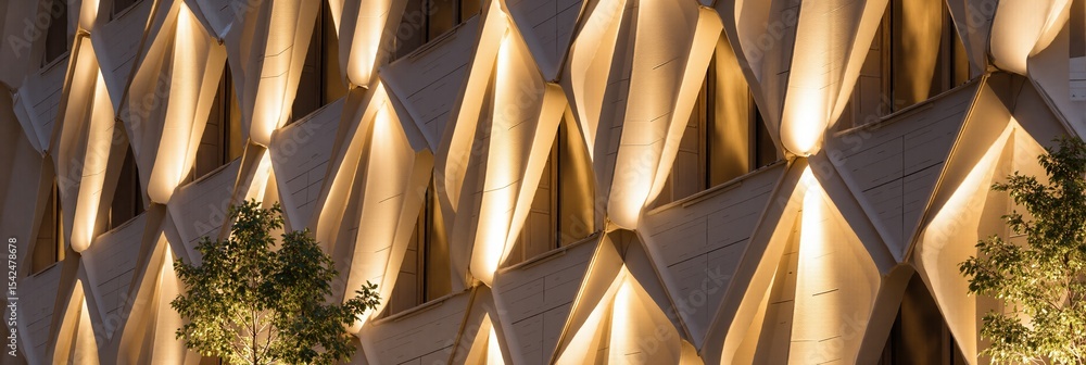 Aufkleber modern building facade with geometric pattern and illuminated uplighting. abstract architectural des