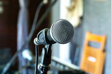 Close-up of a microphone in a home studio setting ready for a recording session