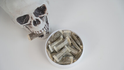 Skull Chewing Tobacco on a White Table.