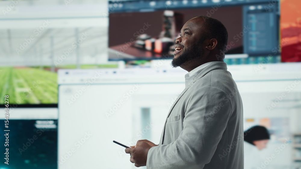 Poster smiling man using mobile phone surrounded by video recommendations while browsing streaming services