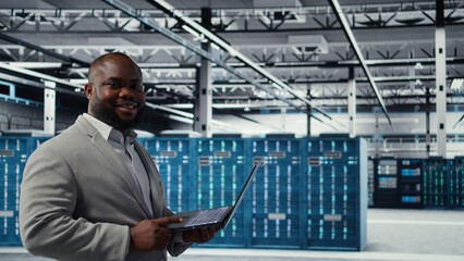 Data center software developer using tablet to do AI algorithms improvements. Programmer in server...