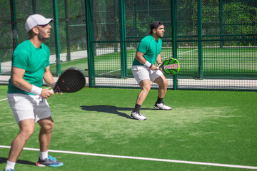 Two padel players. Energetic padel game moment ideal for social media posts and sports ads