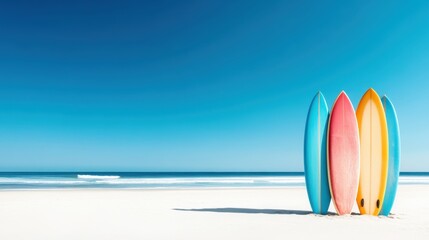 A lineup of colorful surfboards stands proudly on the sandy beach with a clear blue sky and ocean waves in the background, embodying the spirit of summer and adventure.