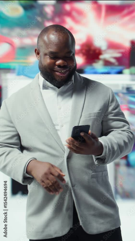 Poster vertical video happy person uses phone, unwinding with curated digital video content. joyous man bro