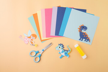 Colorful paper craft setup with fairy and dinosaur characters for educational publishers, DIY...