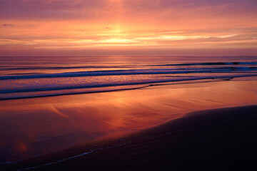 Fototapeta premium Golden Sunset on Rippled Coastal Sand – Tranquil Seaside Landscape for Adobe Stock