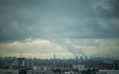 Panoramic view of a city with numerous residential buildings and an industrial area in the...