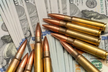 Ammunition and American dollars. The composition emphasises the relationship between guns, power and money.