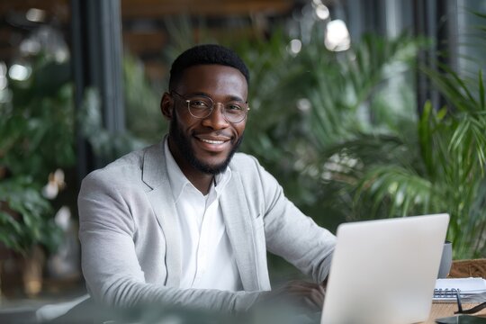 Creative African American advisor enhancing client satisfaction via laptop tech in digital marketing for corporate teamwork