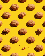 Colorful pattern of sweet cookies on yellow background. Top view.