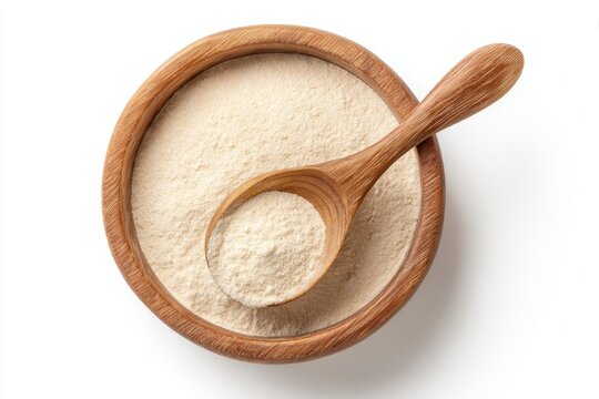 Top view of a bowl and spoon containing active dry yeast on a white background