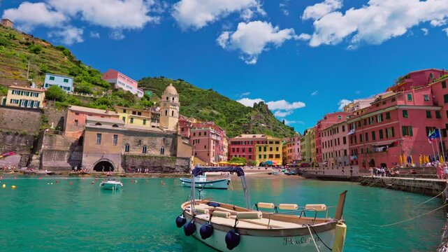 Still shot of Vernazza&rsquo;s harbor with calm sea and vivid village houses under the sun