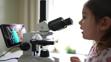 Young girl exploring science with microscope for education and learning at home experiment lab work - Powered by Adobe