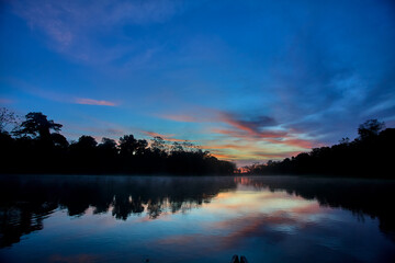 A breathtaking sunrise over the mirrored waters of Pacaya Samiria, where silence, mist, and color merge into one of nature’s most sacred rituals. Deep in the heart of the Peruvian rainforest.