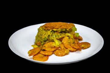 Traditional Bahian acarajé fried in palm oil, of African origin prepared with black-eyed peas, vatapá, caruru, dried and salted shrimp, salad, pepper sauce
