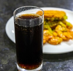 Traditional Bahian acarajé fried in palm oil, of African origin prepared with black-eyed peas, vatapá, caruru, dried and salted shrimp, salad, pepper sauce