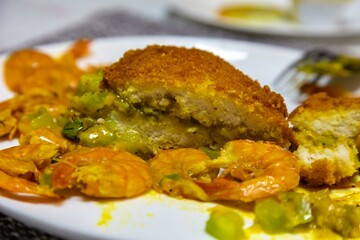 Traditional Bahian acarajé fried in palm oil, of African origin prepared with black-eyed peas, vatapá, caruru, dried and salted shrimp, salad, pepper sauce